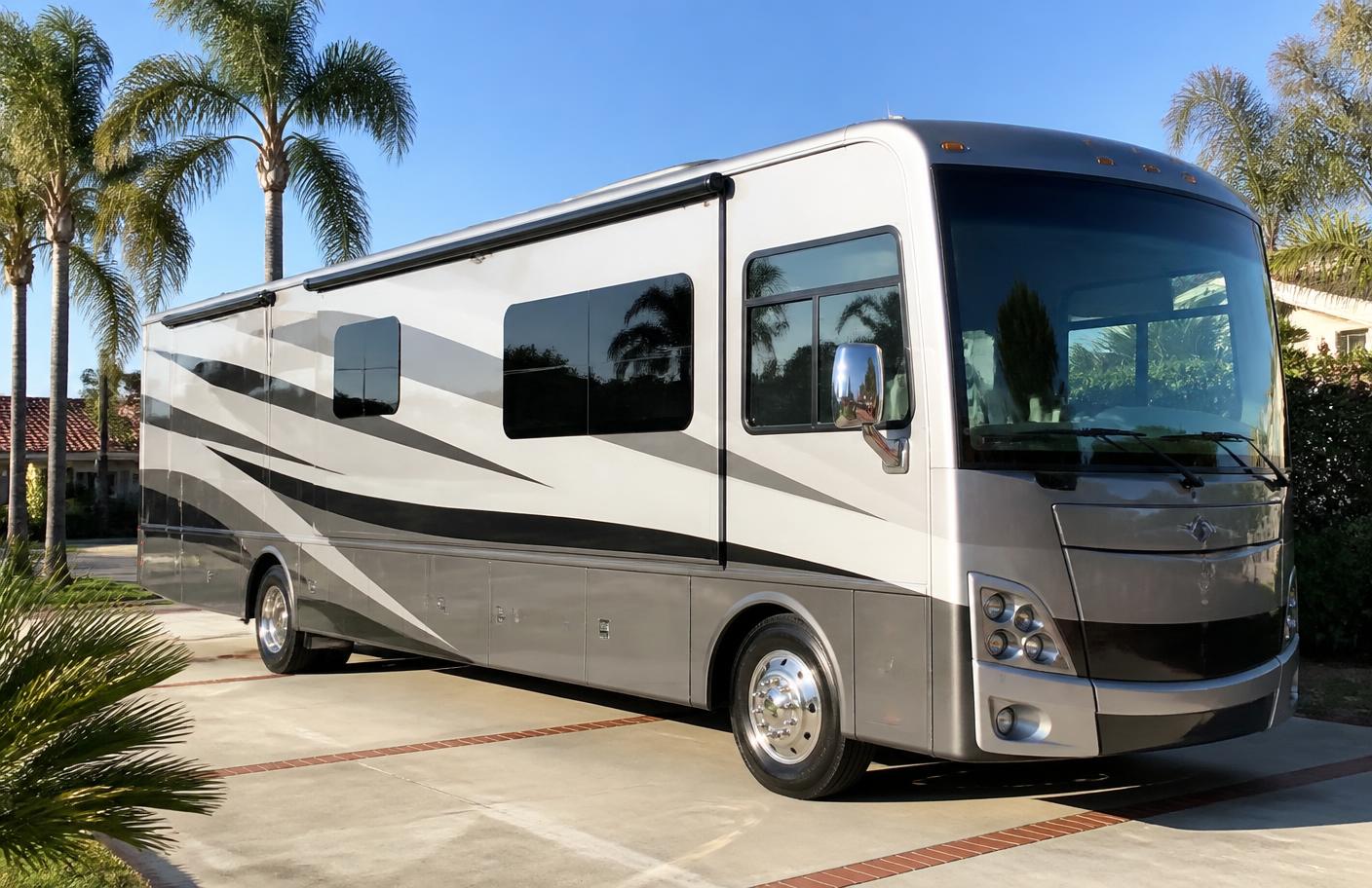 Clean Class A motorhome with glossy sidewalls parked in a Southern California driveway